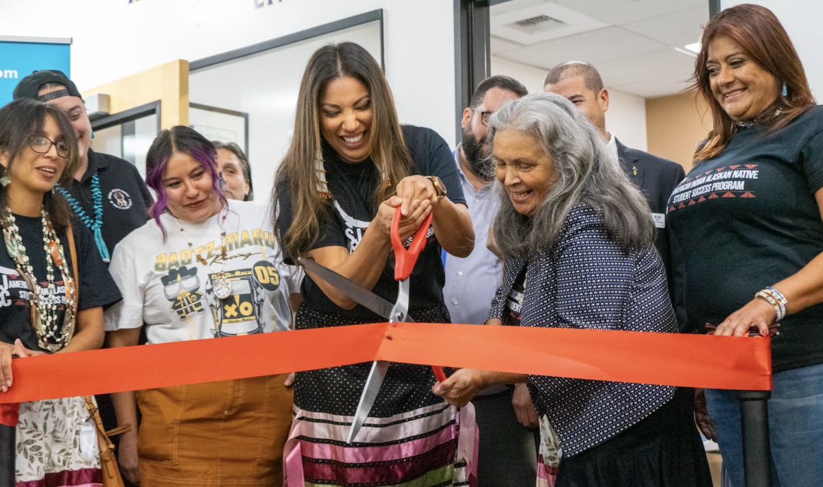 American Indian and Alaskan Native Student Success Center program coordinators Elena Dutra (holding scissors) and Carol Vasquez (right of Elena) are joined by student speakers and community organizers during the grand opening and ribbon cutting ceremony for the indigenous resource center on Wednesday, Oct. 9, 2024 inside the Learning Resource Center at San Jose City College. 